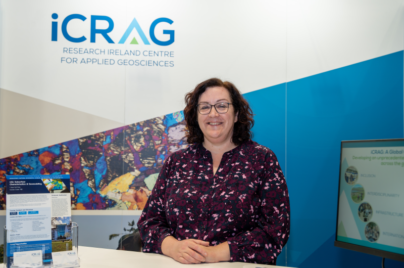Sarah A Gleeso standing in front of the iCRAG exhibition stand